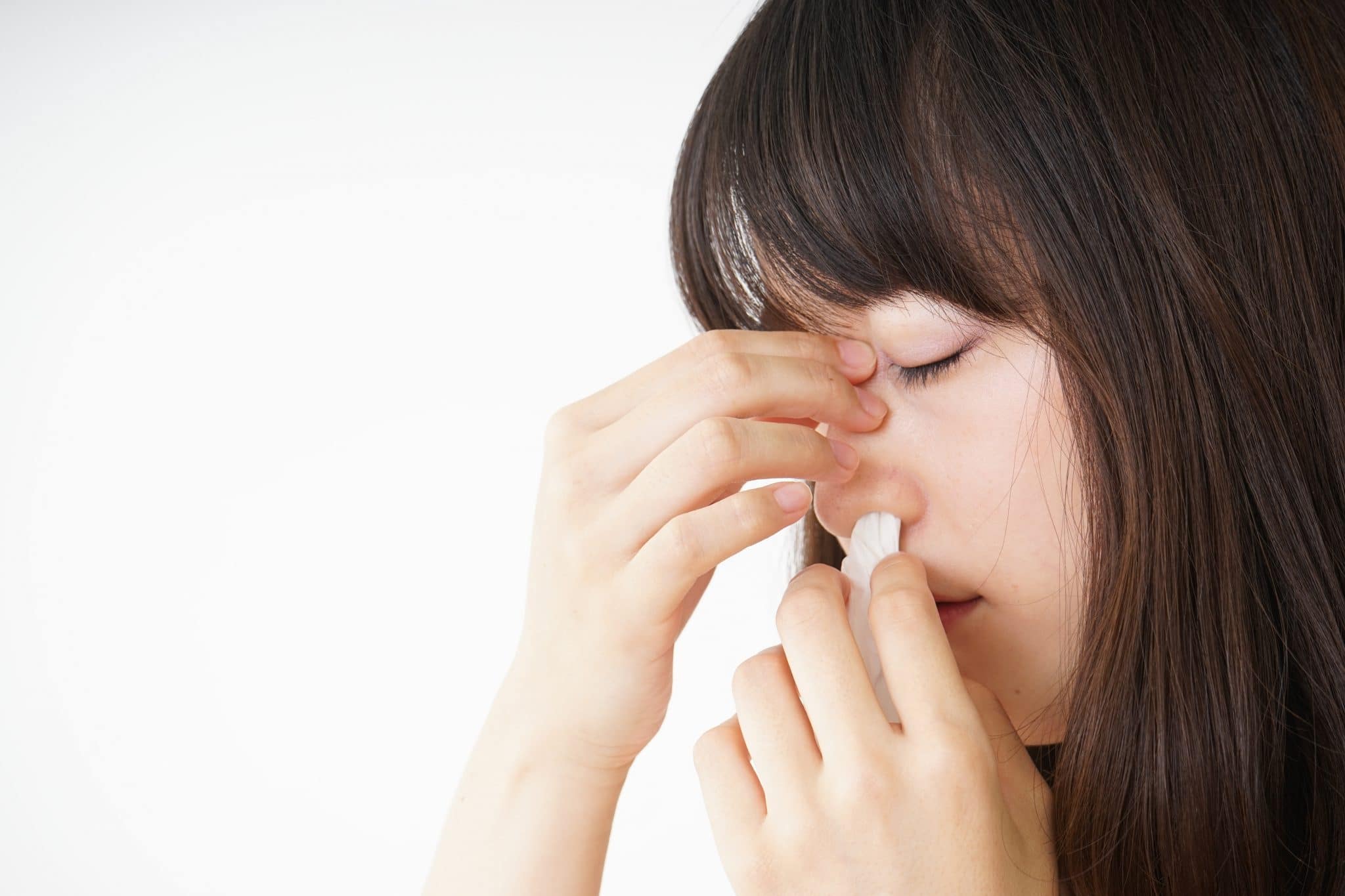 Young woman getting a nosebleed.
