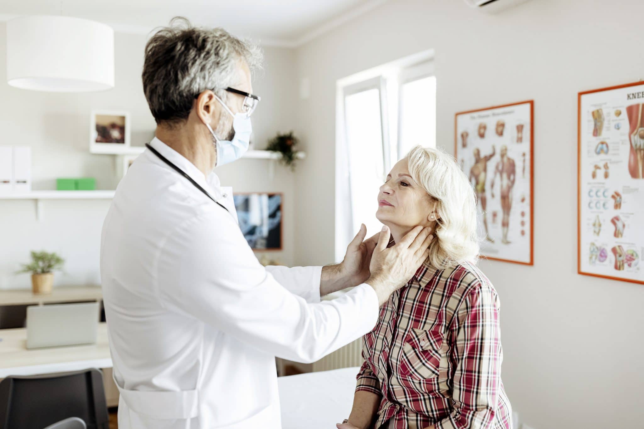 Doctor giving a patient a throat exam.