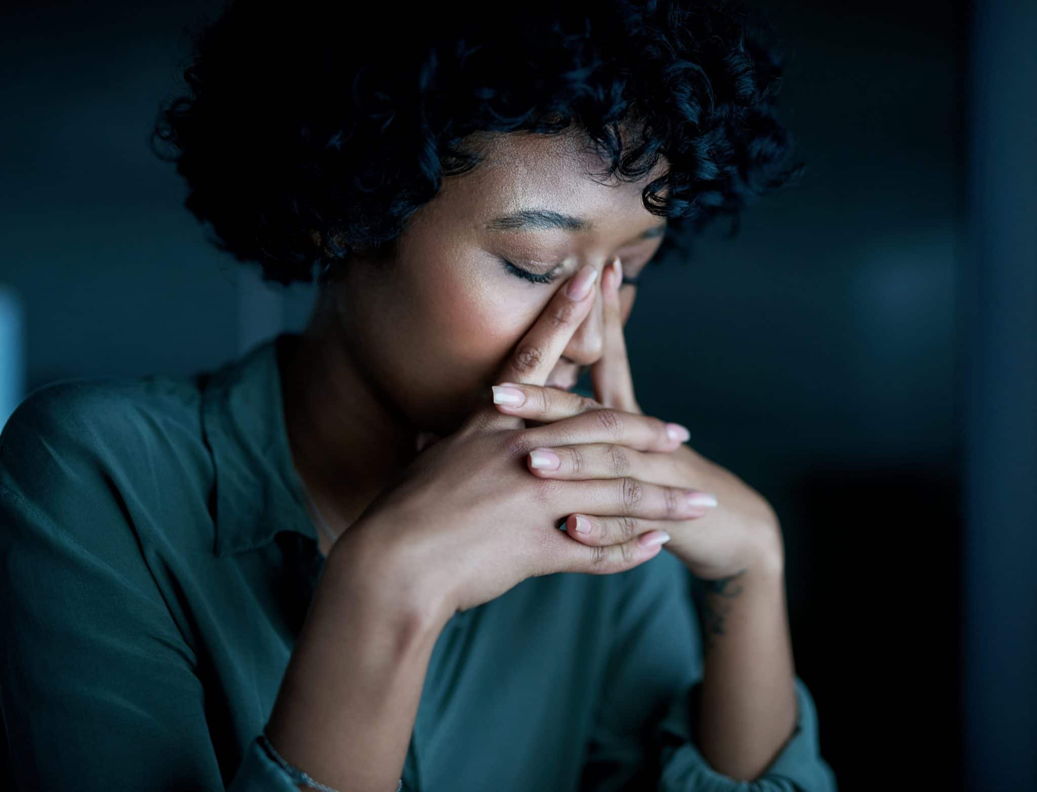 Woman experiencing sinus pressure.