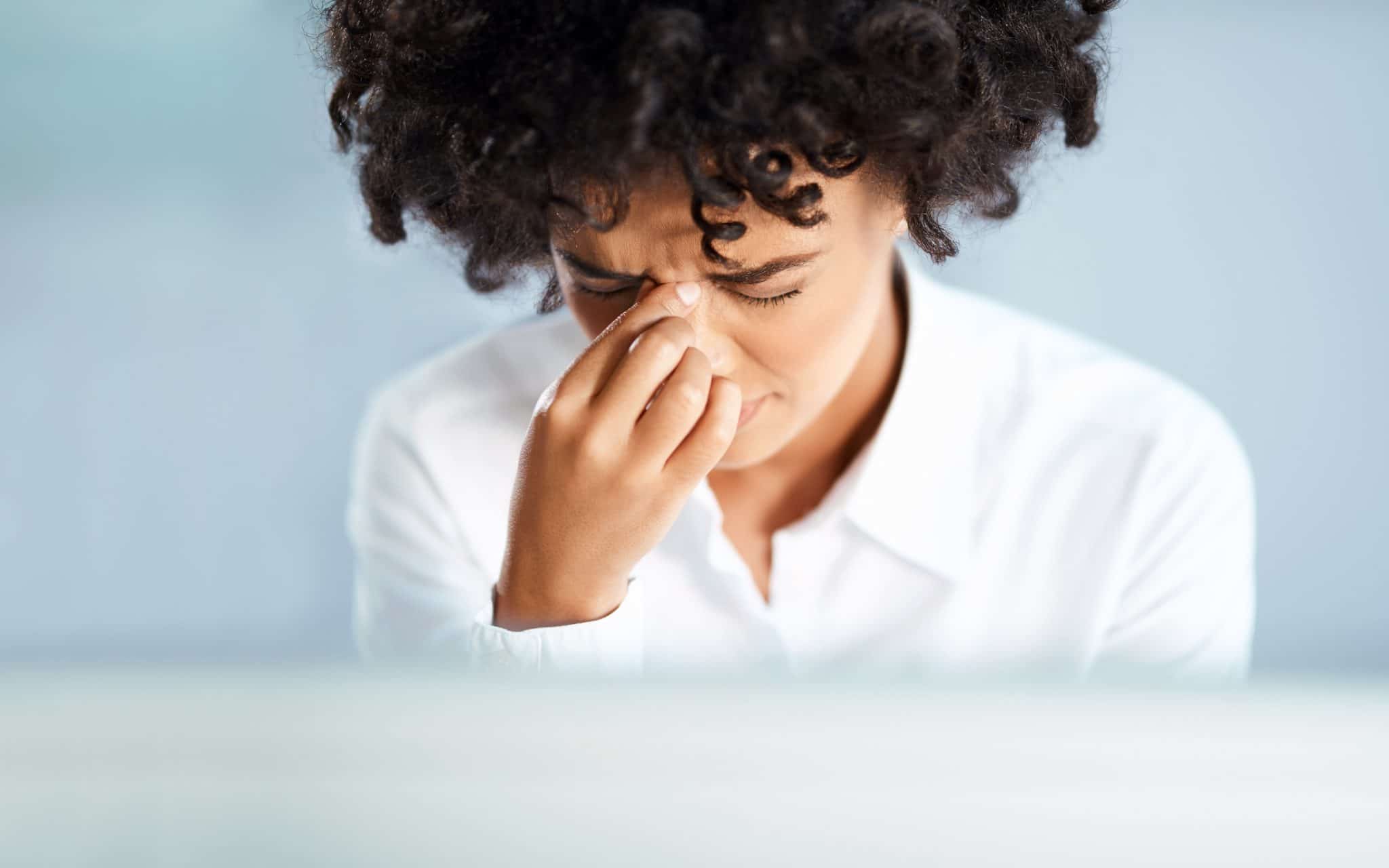 A woman experiencing sinus pressure.