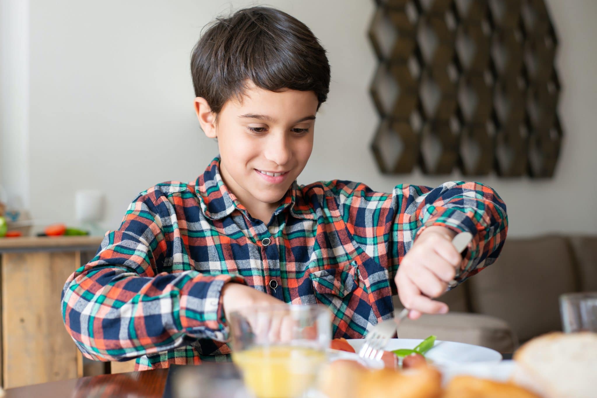 Young boy enjoying a meal at home.