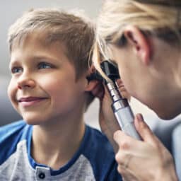 Little boy getting an ear exam from his doctor.