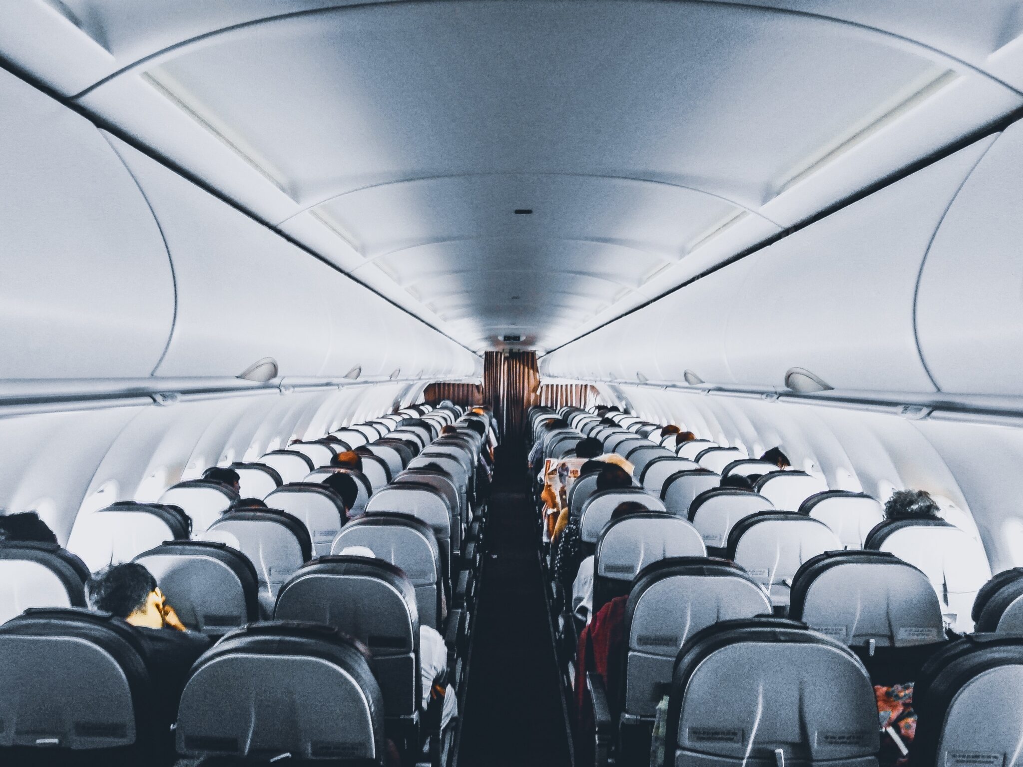 Passengers aboard an airplane cabin.