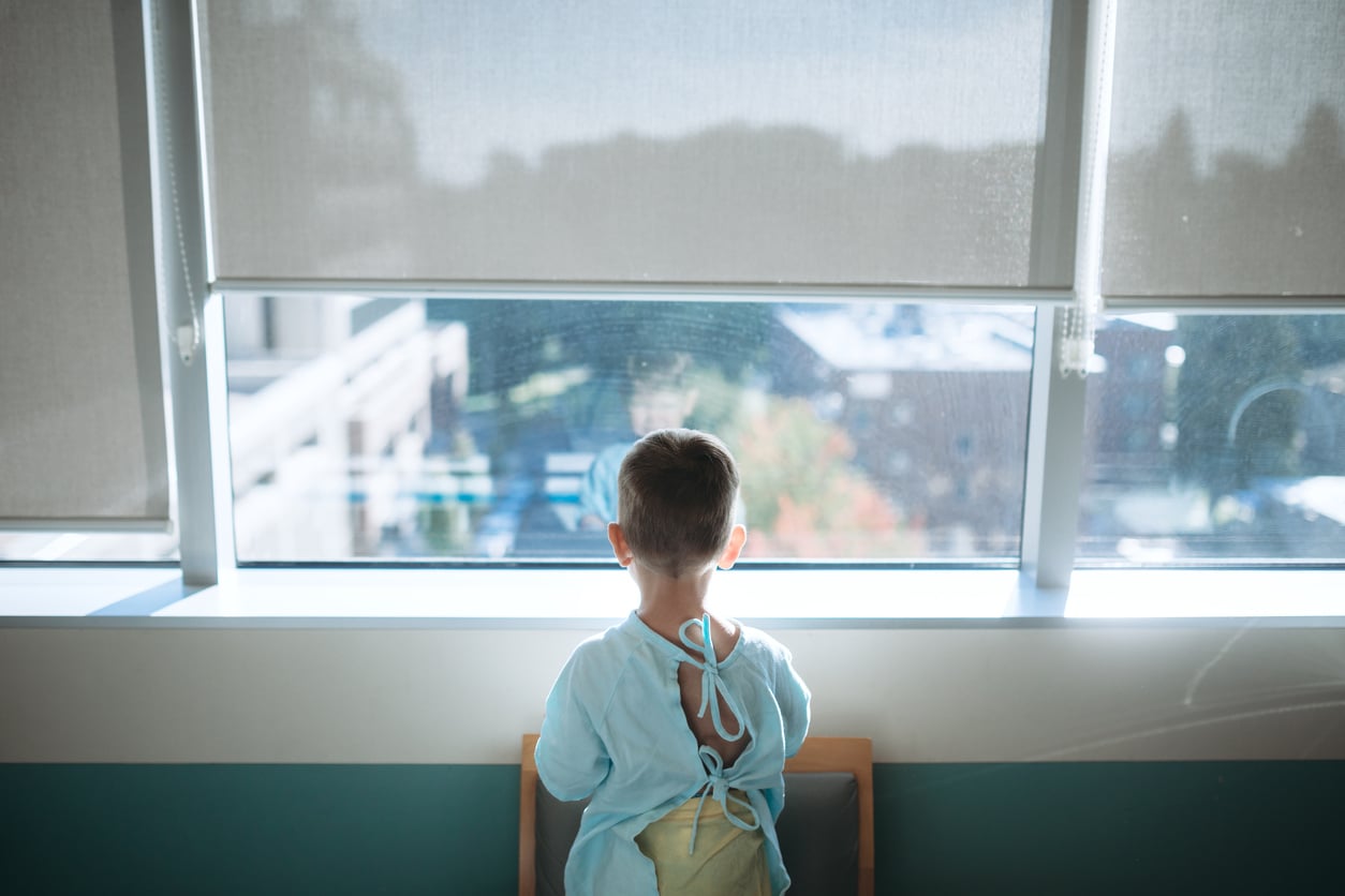 Young boy looks out window prior to surgery