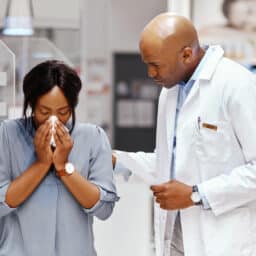 Woman with sinus exam at ENT office with doctor