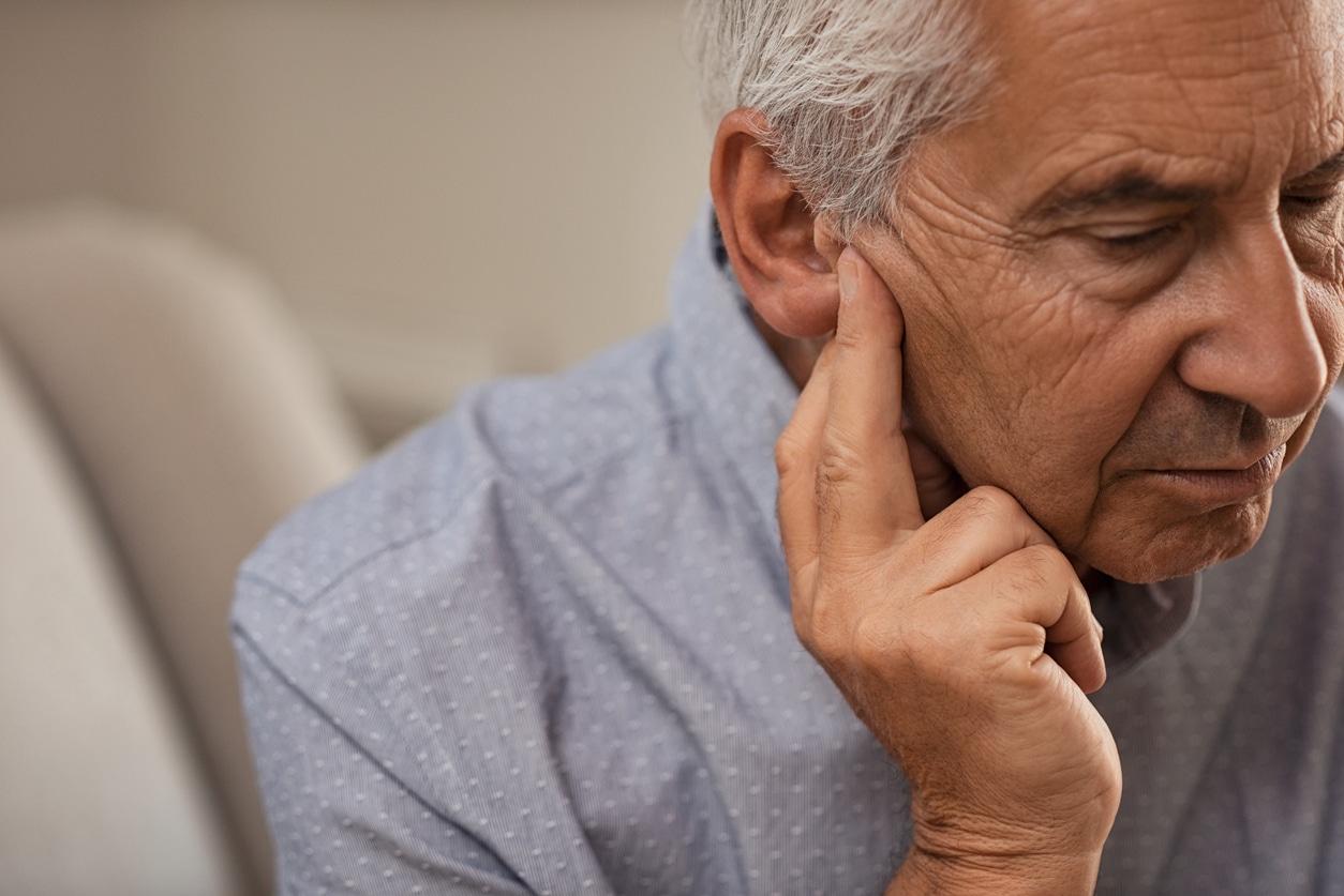 Man holds ear