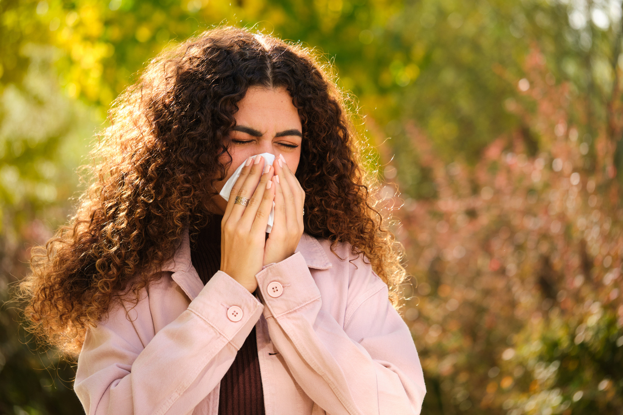 Woman with allergies sneezes