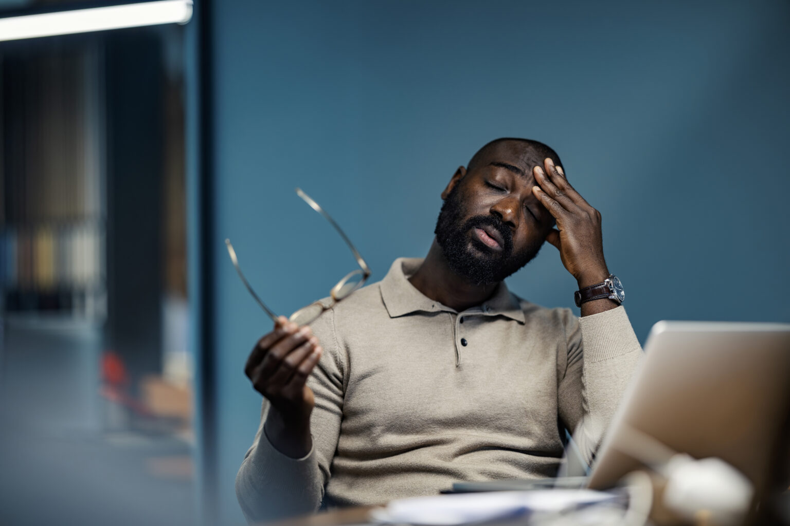After a meeting, a man experiences fatigue from the long stint of listening closely.