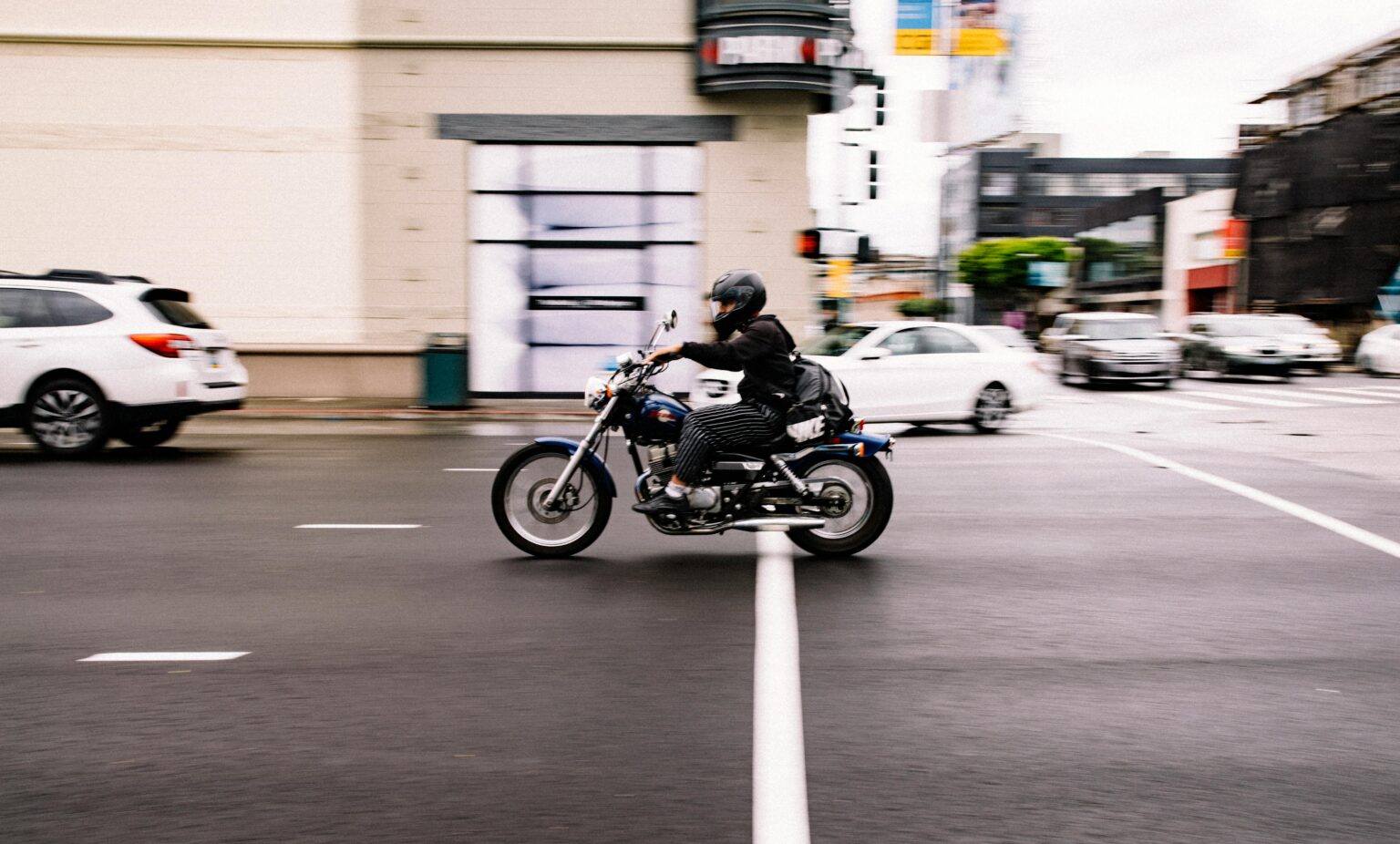 Motorcycle driver in an intersection in a busy city.