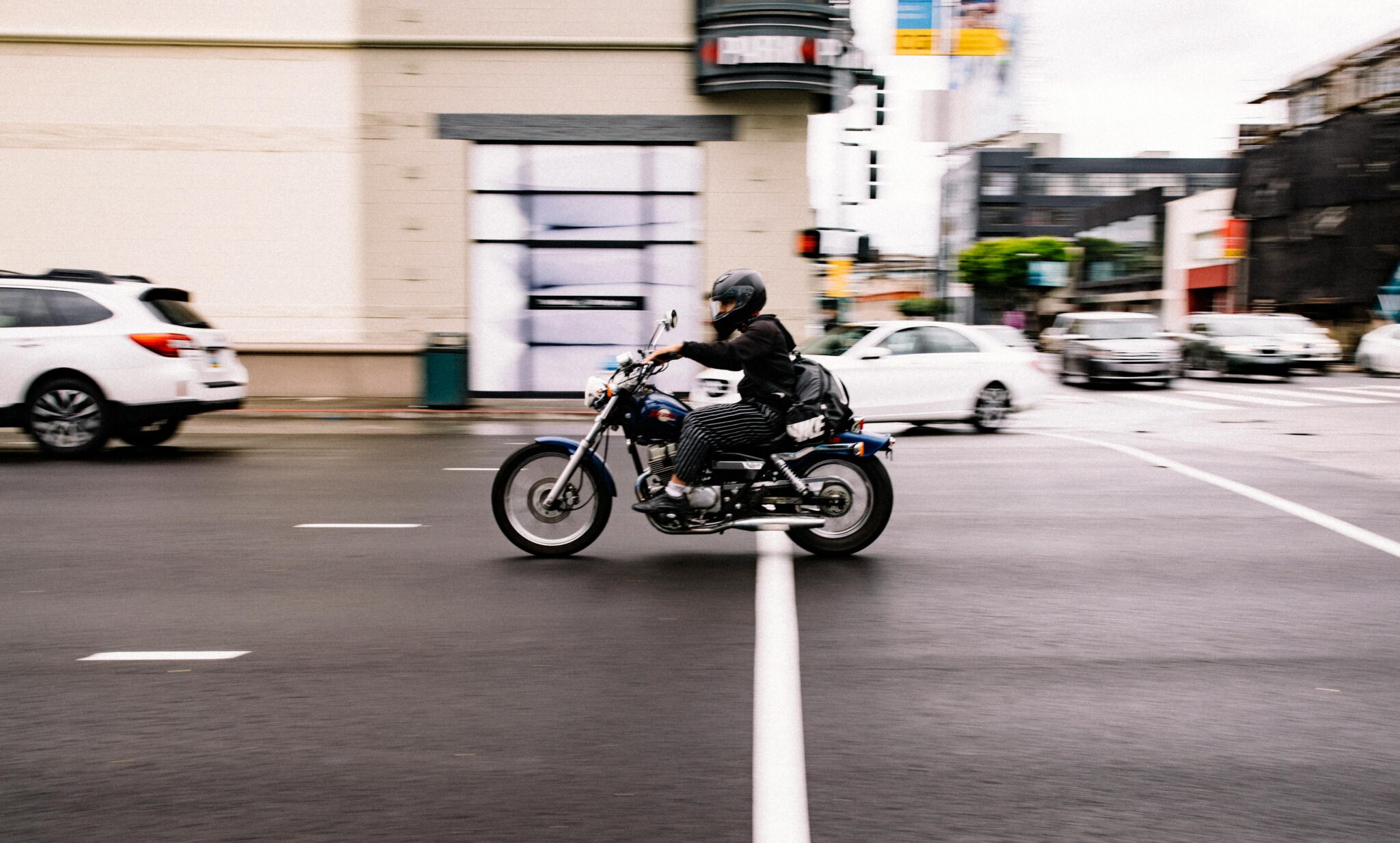 Motorcycle driver in an intersection in a busy city.