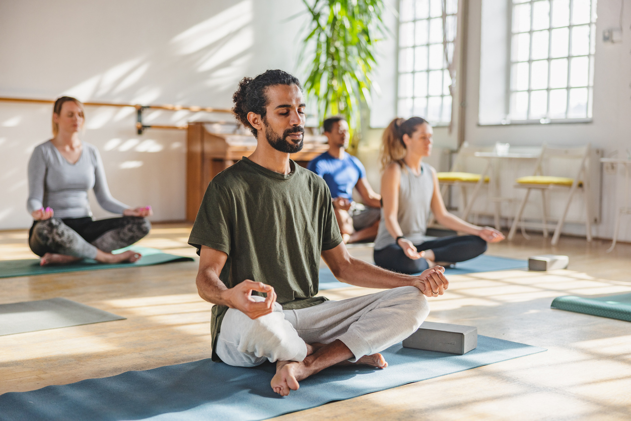 Man breathes peacefully during a group meditation class